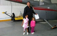 Jose Ricardo Cabrera with his granddaughters, in front of the Robinson R66 just before it crashed