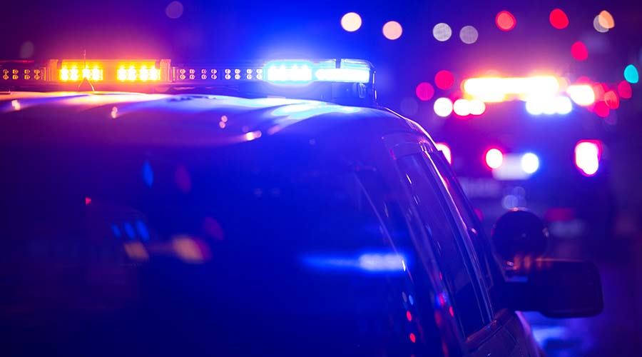 police car with bright lights at night