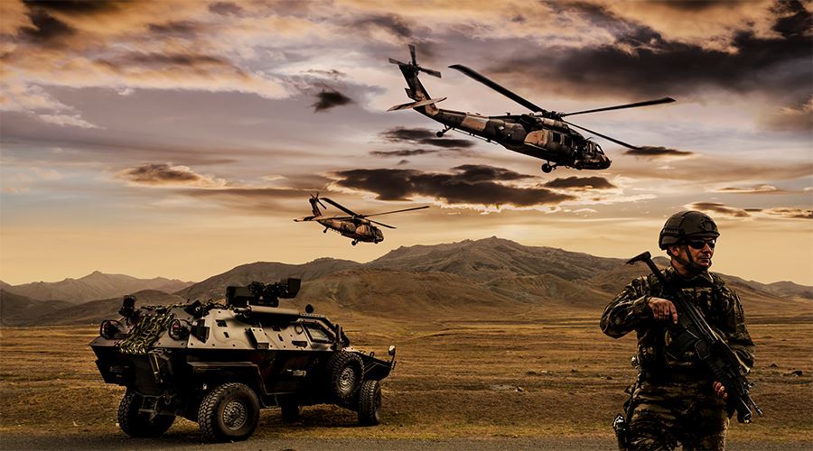 military helicopters in the air while a soldier and tank are on the ground