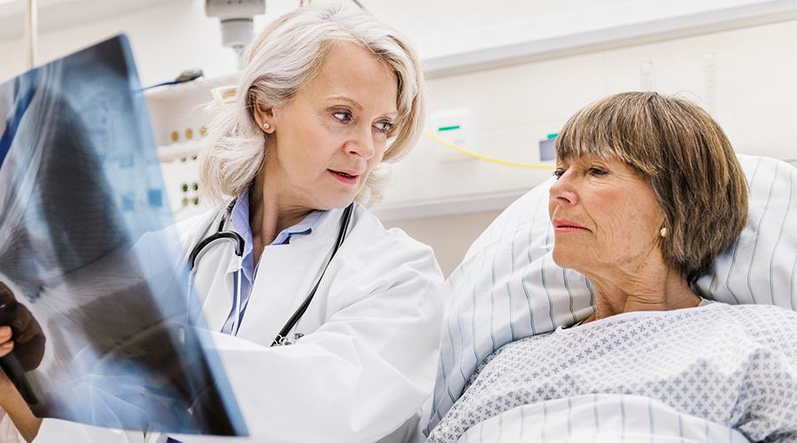 doctor showing a patient x-rays