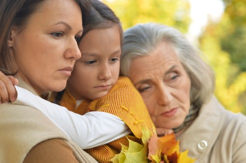 sad family members grieving at a funeral