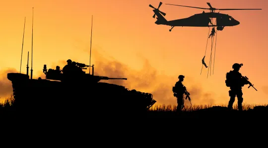 Conceptual image of war with soldier silhouette against a sunset background